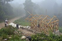 Biosphoto | 1604321 | A family, victims of the earthquake in january 2010, next to their new earthquake-proof house with truss structure, which is made available by a German aid organization, Coq Chante village near Jacmel, Haiti, Caribbean, Central America | © Florian Kopp / imageBROKER / Biosphoto