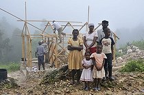 Biosphoto | 1604322 | A family, victims of the earthquake in january 2010, next to their new earthquake-proof house with truss structure, which is made available by a German aid organization, Coq Chante village near Jacmel, Haiti, Caribbean, Central America | © Florian Kopp / imageBROKER / Biosphoto