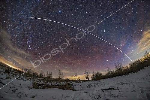Biosphoto | 2481460 | A pass of the International Space Station on the evening of January 26, 2019. The ISS is moving from right to left, southwest to southeast. . . The ISS faded and reddened naturally into sunset at top left in Taurus. Just before it did that it passed through the Hyades star cluster and just missed Aldebaran. . . The ISS seemed to track along the ecliptic here, made somewhat visible by the faint arc of the zodiacal light reaching up from the horizon at right and stretching across the sky to the upper left. The ISS coincidentally travelled parallel to, but just below the zodiacal light, which follows the ecliptic. . . Some red streaks of airglow are also visible, and I emphasized those in the colour correction to make a more colourful sky. I did the opposite to the light polluted clouds! But their yellow remains.
 | © Alan Dyer / Stocktrek Images / Biosphoto