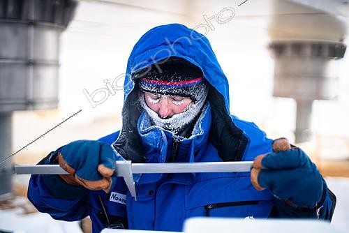 Biosphoto | 2595528 | A scientist makes a series of measurements on a piece of snow to determine its structure, hardness, etc. near the feet of the Concordia station. Concordia Antarctic Research Station, Dome C plateau, East Antarctica. | &copy; Armand Patoir / Biosphoto