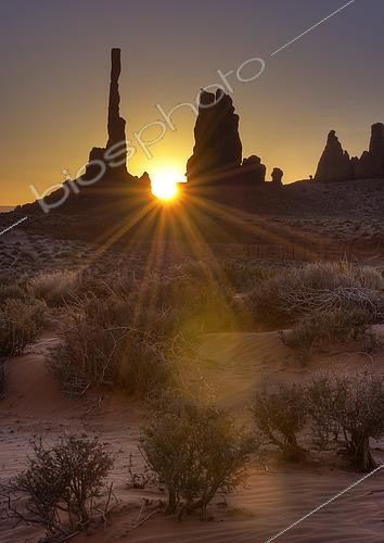Biosphoto | 2482630 | A sunburst through the famous Totem Pole formation in Monument Valley, Utah. | &copy; John Davis / Stocktrek Images / Biosphoto