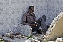 Biosphoto | 1603643 | Believer with bible in the rubble of a house, Turgeau district, Port-au-Prince, Haiti, Caribbean, Central America | © Florian Kopp / imageBROKER / Biosphoto