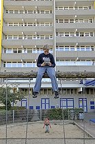 Biosphoto | 1605591 | Boy, 9, playing with his Nintendo in front of a high-rise apartment building, satellite town of Chorweiler in Cologne, North Rhine-Westphalia, Germany, Europe | © Walter G. Allgoewer / imageBROKER / Biosphoto
