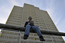Biosphoto | 1605593 | Boy, 9, playing with his Nintendo in front of a high-rise apartment building, satellite town of Chorweiler in Cologne, North Rhine-Westphalia, Germany, Europe | © Walter G. Allgoewer / imageBROKER / Biosphoto