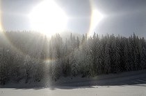 Biosphoto | 1254380 | Bright halo above a snowy forest Vosges France | &copy; Denis Bringard / Biosphoto