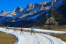 Biosphoto | 2563589 | Cross-country skiers in front of Massif des Aravis, artificial snow, snowless winter, Espace Nordique of Confins, La Clusaz, Savoy, France, Europe | &copy; Guenter Fischer / imageBROKER / Biosphoto