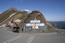 Biosphoto | 2588032 | Cyclist arriving by road and bike at the Col du Gallibier pass in summer and sign at the pass in Valloire, Savoie, France. | &copy; Antoine Boureau / Biosphoto