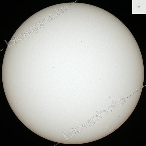 Biosphoto | 1255019 | International Space Station passing by the Sun ; ISS passes the Sun's disk. At a rate of 3 frames per second, the space station has left 7 times its black silhouette. Top right, a detail of the best photos. A small sunspot is visible left of center of the Sun.  | &copy; Laurent Laveder / Biosphoto