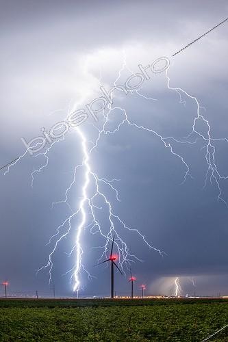 Biosphoto | 2025484 | Lightning and wind in the evening countryside - France ; Many ascending tracers are visible and leave the blades of the wind turbine.  | &copy; Xavier Delorme / Biosphoto