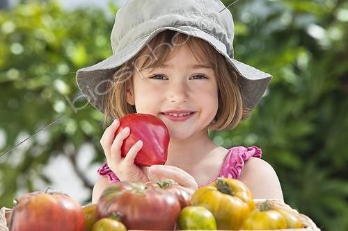 Biosphoto | 1255195 | Little girl holding a Tomatoe 'Coeur de boeuf' ; 5 years old girl | &copy; Frédérique Bidault / Biosphoto
