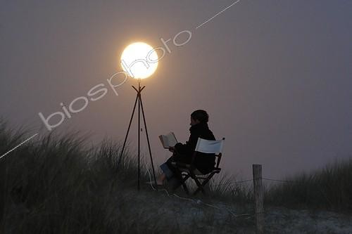 Biosphoto | 1255224 | Man giving the impression of reading with like moon light  | &copy; Laurent Laveder / Biosphoto