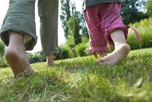 Biosphoto | 1127831 | Mother and daughter walking barefoot on grass France | &copy; Marc Chatelain / Biosphoto