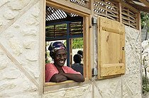 Biosphoto | 1604327 | Resident laughing from the window of her new earthquake-safe house donated by a German aid organisation, Froide River village near Port-au-Prince, Haiti, Caribbean, Central America | © Florian Kopp / imageBROKER / Biosphoto
