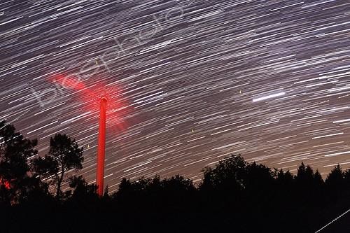 Biosphoto | 1159876 | Stars and satellites over a wind turbine ; In summer, when astronomical twilight, the satellites are visible from lower and lower toward the southern hemisphere, because the cone of Earth's shadow falls as the sun rises on approaching the horizon north-east. | &copy; Laurent Laveder / Biosphoto