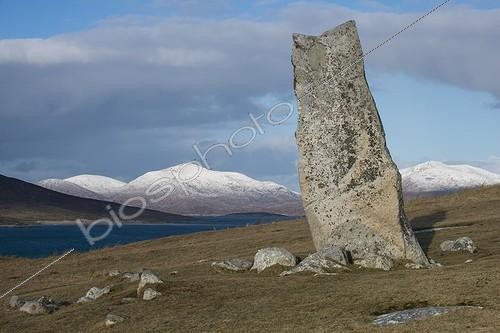 Biosphoto | 2048662 | Stone MacLeod - Harris Hebrides ; Menhir above Traigh Iar beach on the Isle of Harris in Scotland. We see the snowy mountains of Harris and one end of the island of Taransay left. | &copy; Duncan MacArthur / Biosphoto