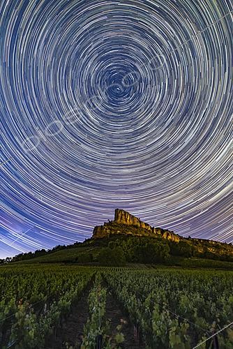 Biosphoto | 2624267 | The rock beneath the Polar Star, the Roche de Solutré is a limestone escarpment that overlooks the vineyards of Burgundy, located 8 km from Mâcon. The birthplace of the famous Pouilly-Fuissé, Solutré and its sister, the Roche de Vergisson, have been beautifully described by Lamartine as  two petrified ships overlooking a sea of vines.  Situated in a plot of Mâcon-Solutré belonging to winemaker Michel Camusat, I captured the apparent movement of the stars for 2 hours, right above the Roche. Solutré-Pouilly, Saône-et-Loire, France. | &copy; Philippe Jacquot / Biosphoto