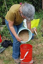 Biosphoto | 2546821 | Woman pouring green manure | &copy; Serge Lapouge / Biosphoto