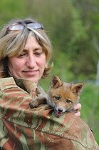 Biosphoto | 1249121 | Young woman carrying a red fox France | &copy; Daniel Heuclin / Biosphoto